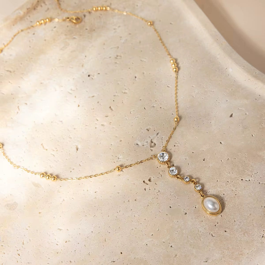 Waterproof gold lariat necklace with mixed-cut geometric crystals for swimming and active wear.