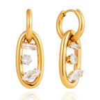 Detail of the baguette, round, and marquise-cut crystals floating within the gold oval link.