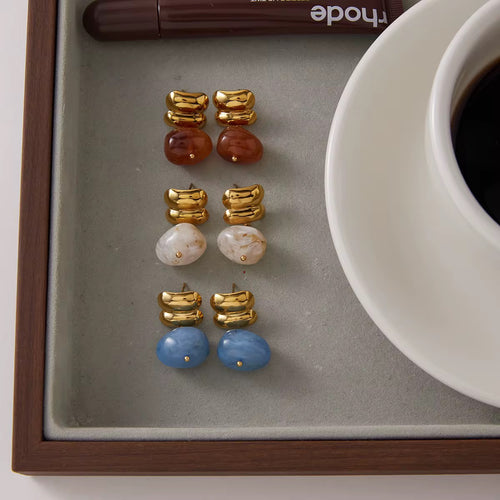 Amber Solstice drop earrings featuring 18k gold PVD plating and red agate stones.