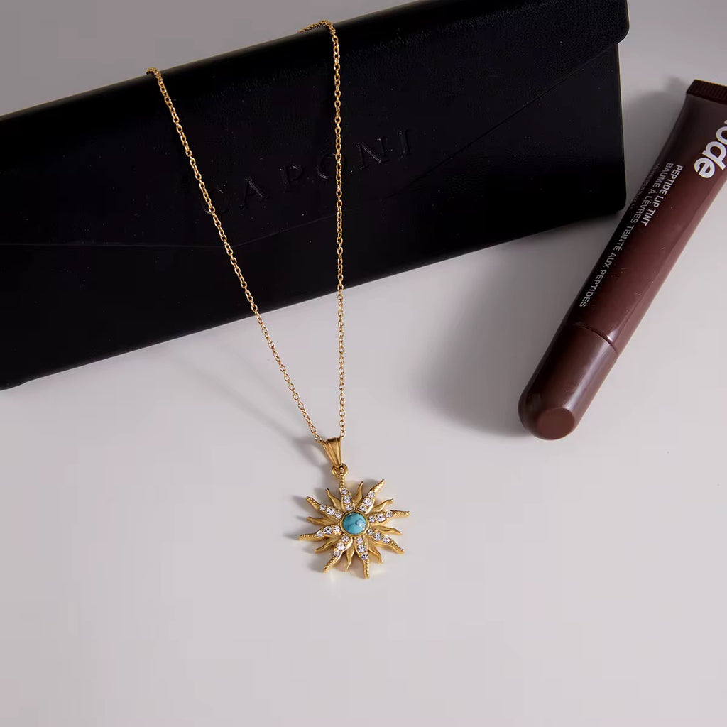 Turquoise Sunburst necklace featuring 18k gold PVD plating and crystal rays.