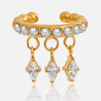 Detail of the vibrant emerald-green diamond-shaped charms on an 18k gold cuff.