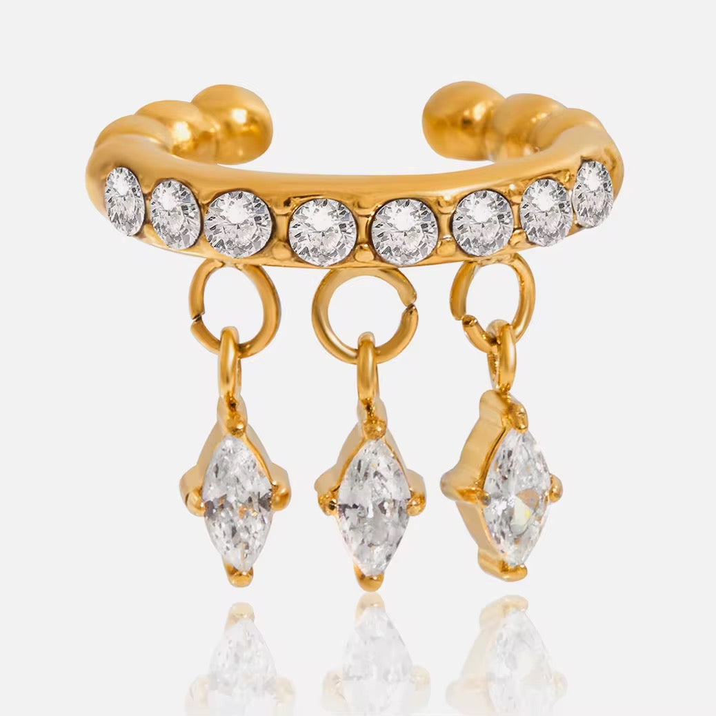 Detail of the vibrant emerald-green diamond-shaped charms on an 18k gold cuff.