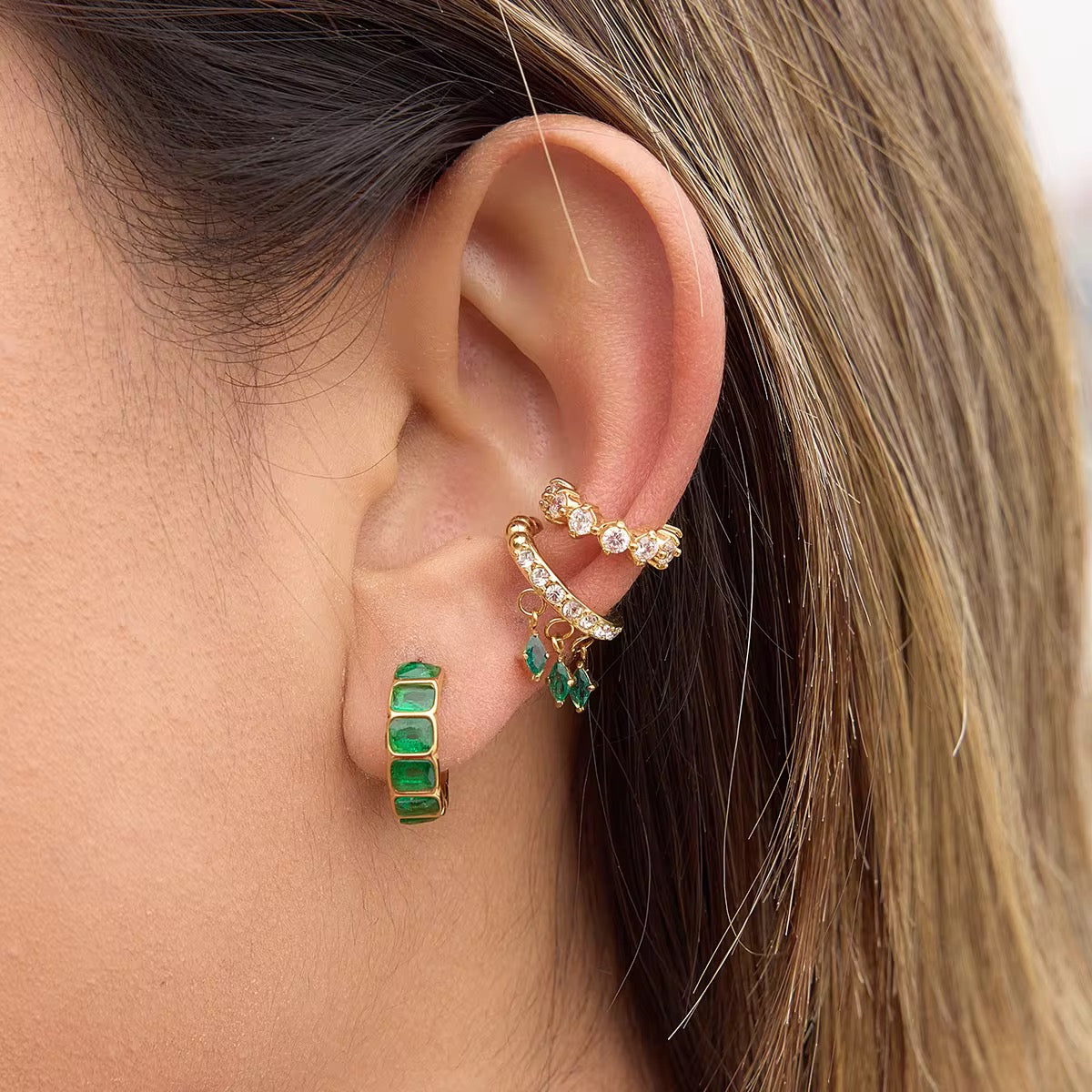 Prism Charm ear cuff in 18k gold PVD plating with dangling Emerald Green stones.
