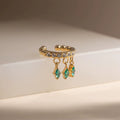 Detail of the brilliant Clear CZ diamond-shaped charms on an 18k gold ear cuff.