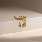 Detail of the brilliant Clear CZ diamond-shaped charms on an 18k gold ear cuff.