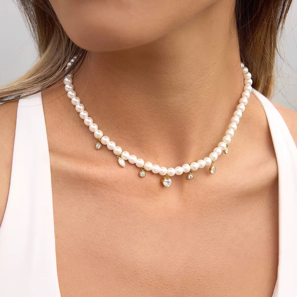 Heart of Pearls necklace featuring 18k gold PVD plating and a large heart crystal pendant.