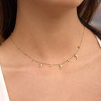 Dolphin Dance necklace featuring 18k gold PVD plating and pavé crystal dolphin charms.