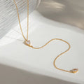 Gilded Tear lariat necklace featuring 18k gold PVD plating and dual teardrop crystals.