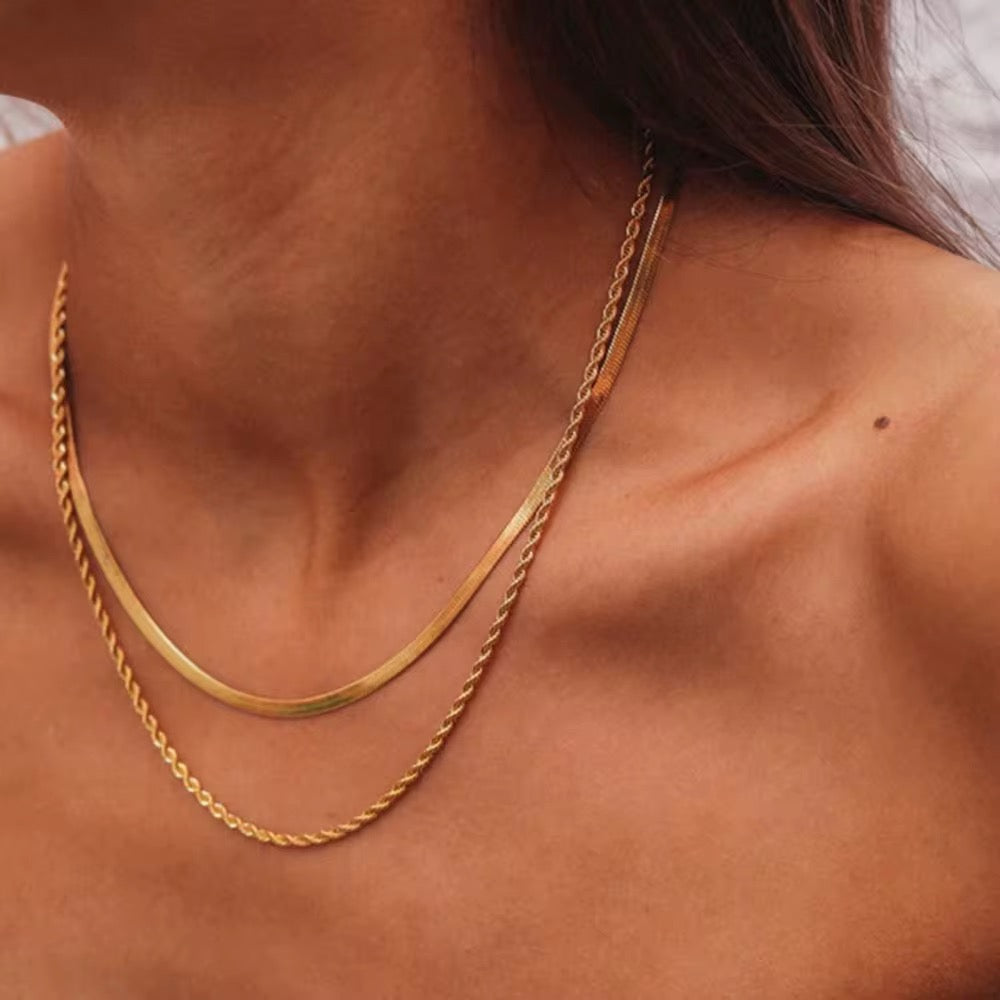 Waterproof gold double-chain necklace for swimming and active lifestyles.