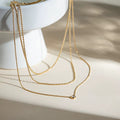 Gilded Trio triple layered necklace featuring 18k gold PVD plating and solitaire crystal.
