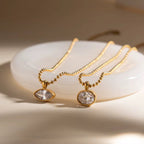 Gilded Vision necklace featuring an 18k gold PVD plated ball-chain and round crystal.