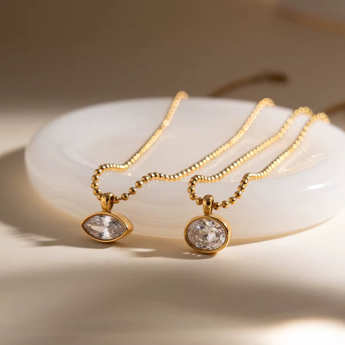 Gilded Vision necklace featuring an 18k gold PVD plated ball-chain and round crystal.