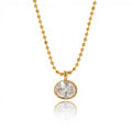 Detail of the secure gold bezel setting on a large round brilliant-cut crystal.