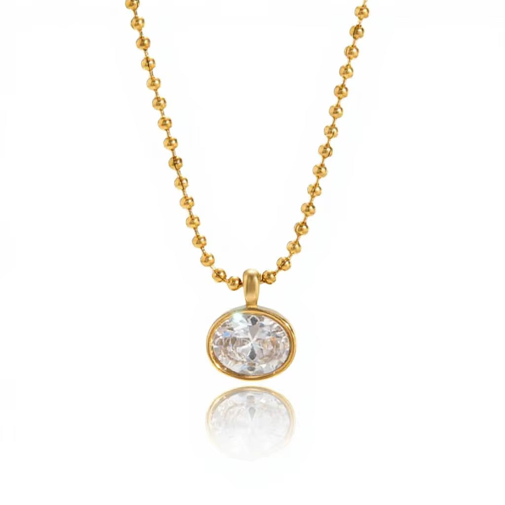 Detail of the secure gold bezel setting on a large round brilliant-cut crystal.