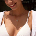 The Grand Slam lariat necklace featuring an 18k gold PVD plated tennis racket.