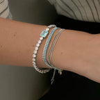 Waterproof silver tennis bracelet with three rows of blue gradient crystals for swimming.