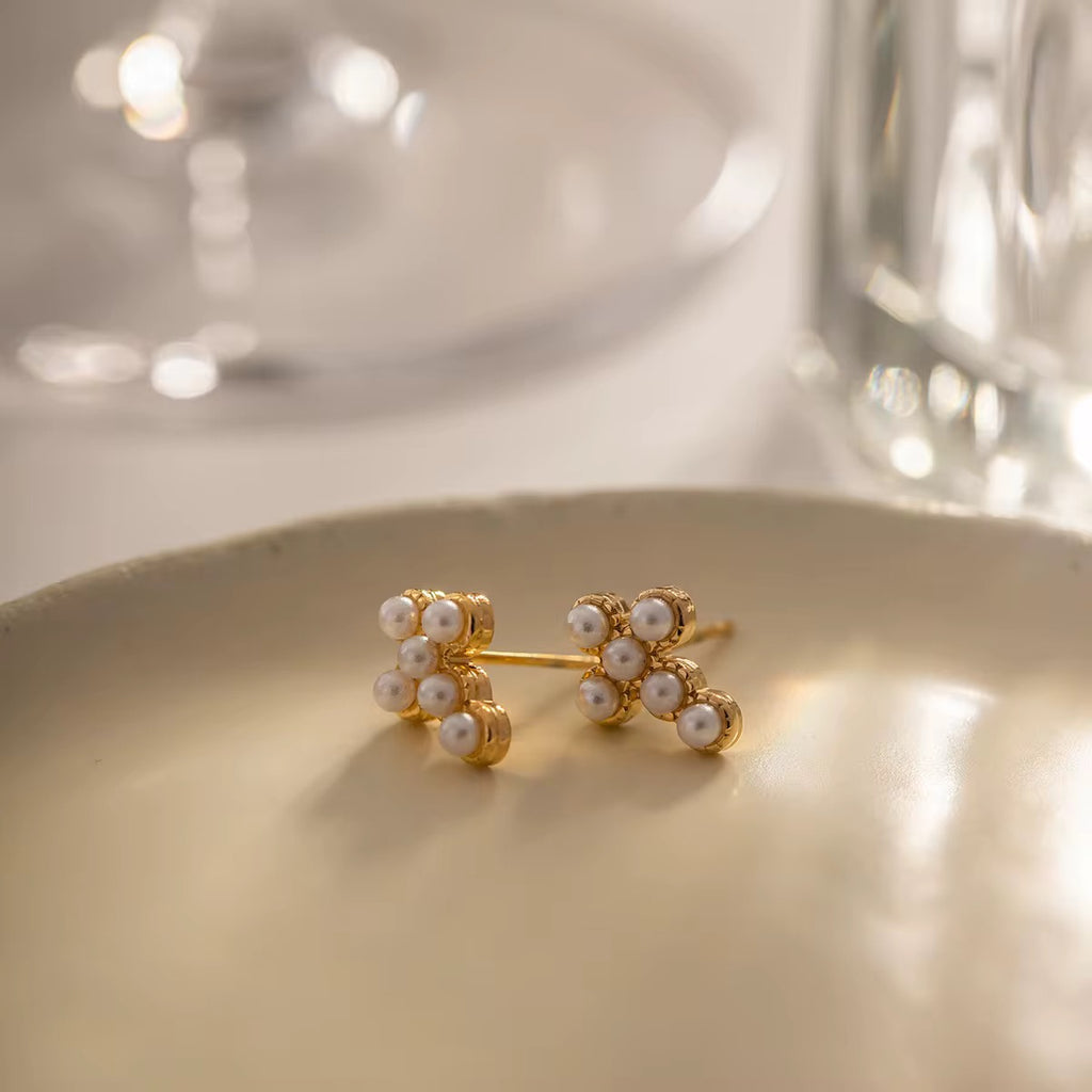 Waterproof gold cross earrings with pearls for swimming and active lifestyles.