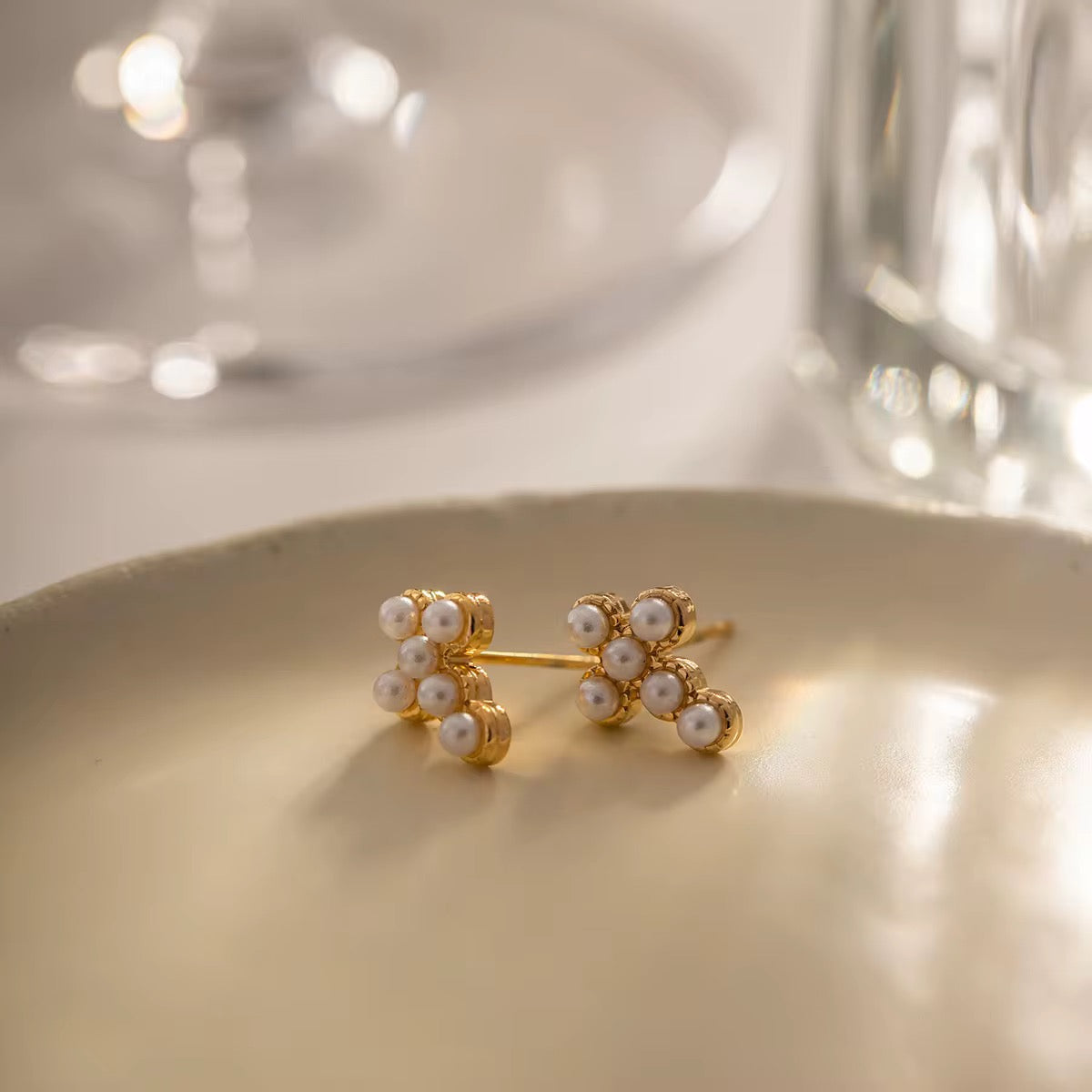Waterproof gold cross earrings with pearls for swimming and active lifestyles.
