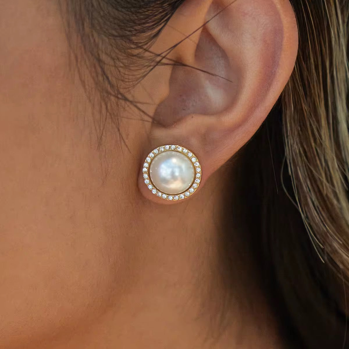Crown Jewel pearl studs featuring 18k gold PVD plating and a crystal halo.