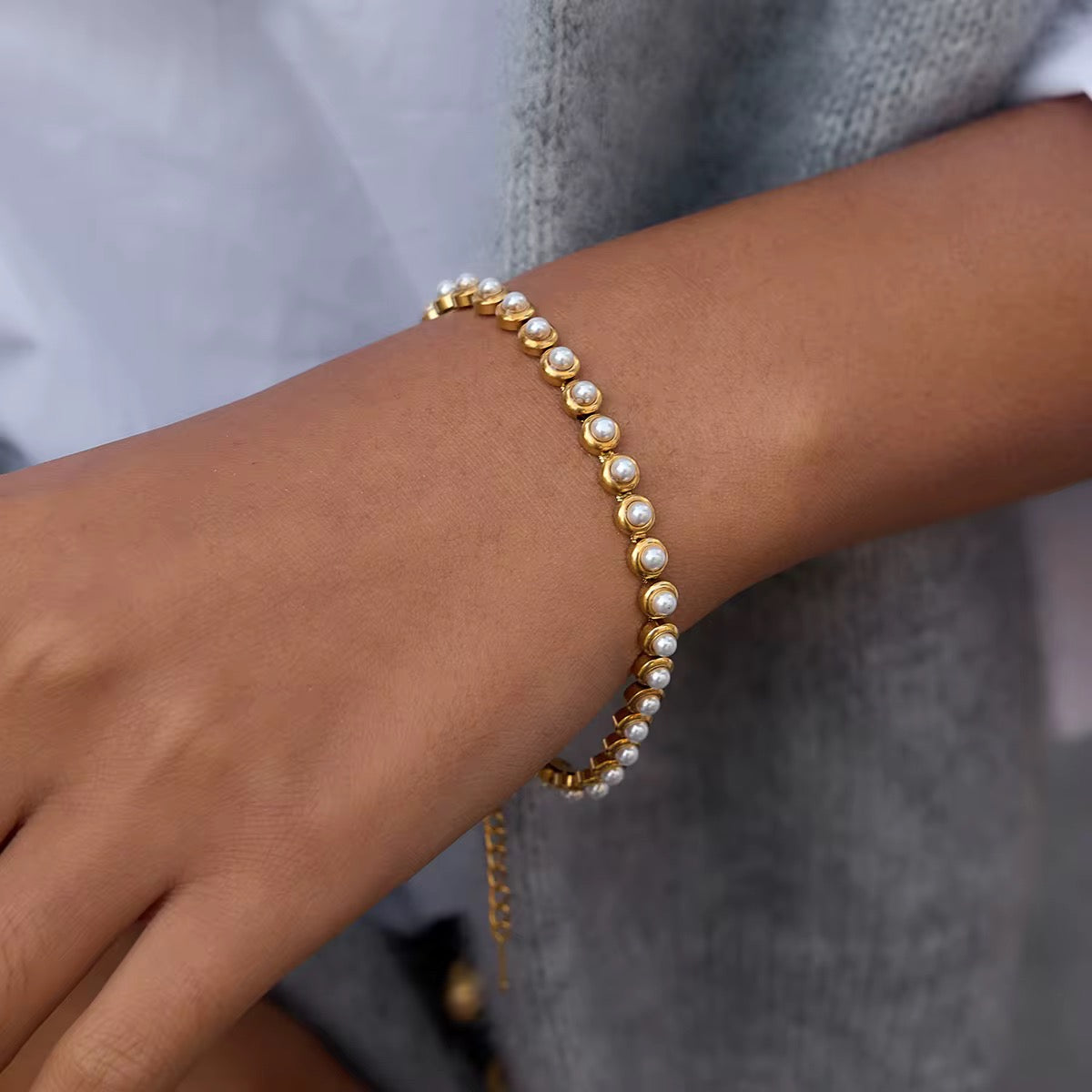Pearl Wisdom bracelet featuring 18k gold PVD plated stainless steel and bezel-set pearls.