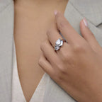Liquid Silver Cross-Over ring featuring dual pear-cut crystals in high-polish stainless steel.