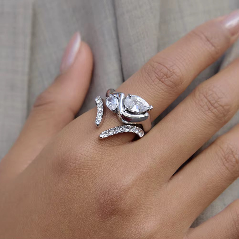 Waterproof silver asymmetrical statement ring with two nested brilliant teardrop stones.