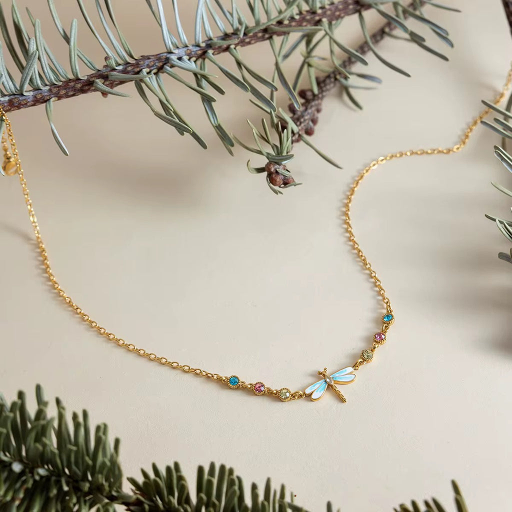 Waterproof Velvet Wings gold necklace with colorful turquoise and pink crystals.