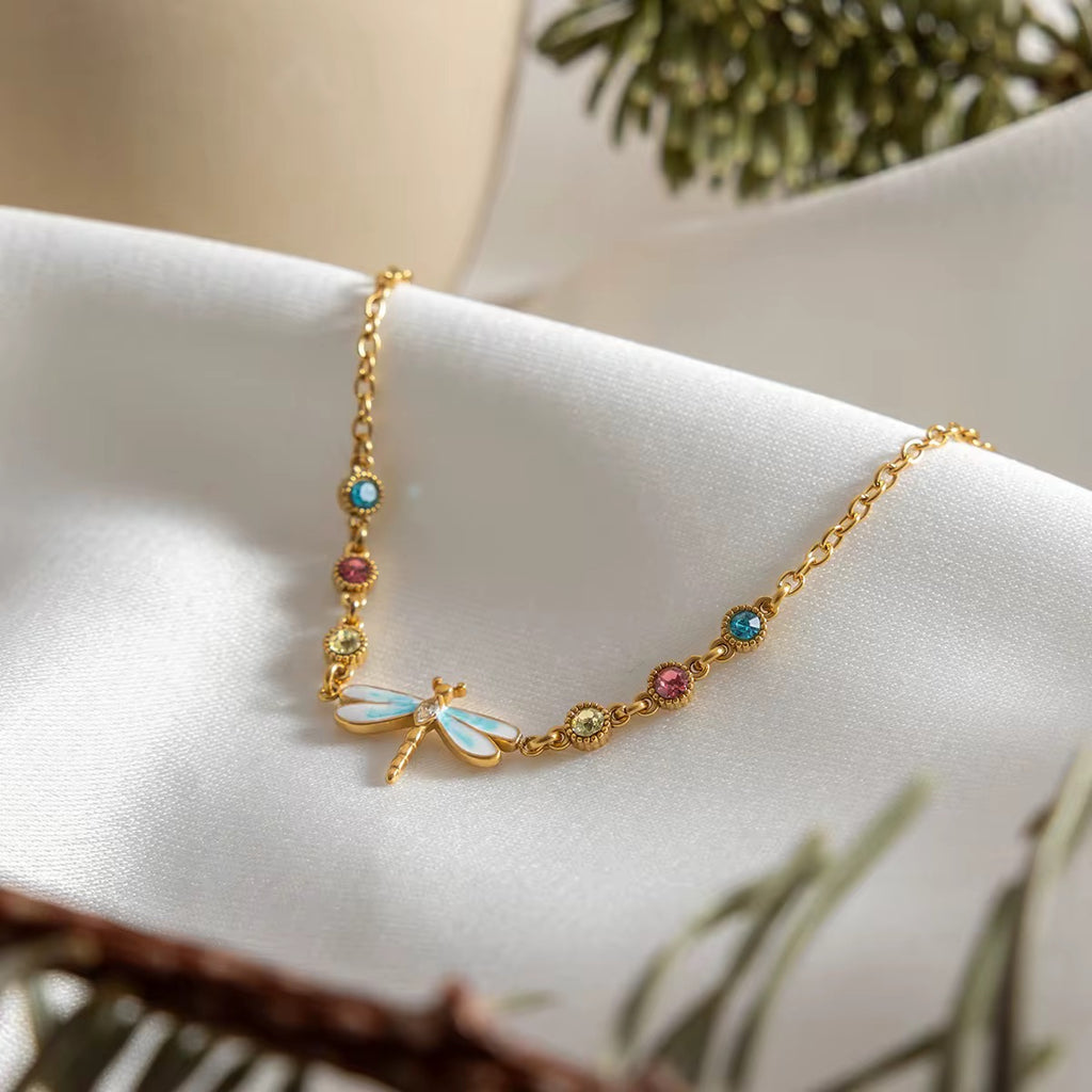 Velvet Wings dragonfly necklace featuring 18k gold PVD plating and blue wings.