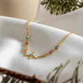 Velvet Wings dragonfly necklace featuring 18k gold PVD plating and blue wings.