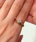 Gilded Teardrop Cross-Over ring featuring 18k gold PVD plated stainless steel and a pear crystal.