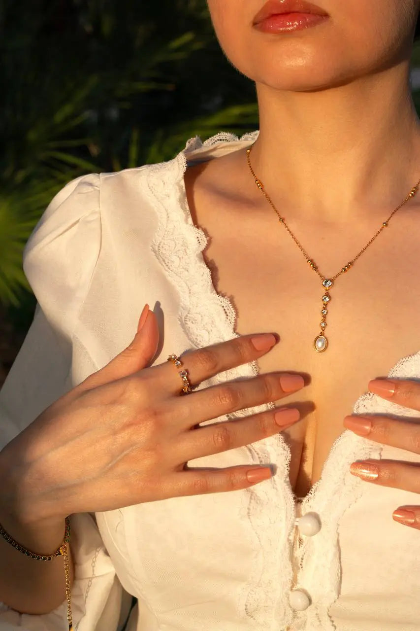 Close-up of a person wearing a necklace with a blurred background