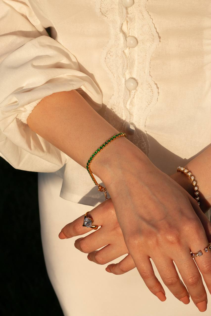Close-up of hands with jewelry on a neutral background