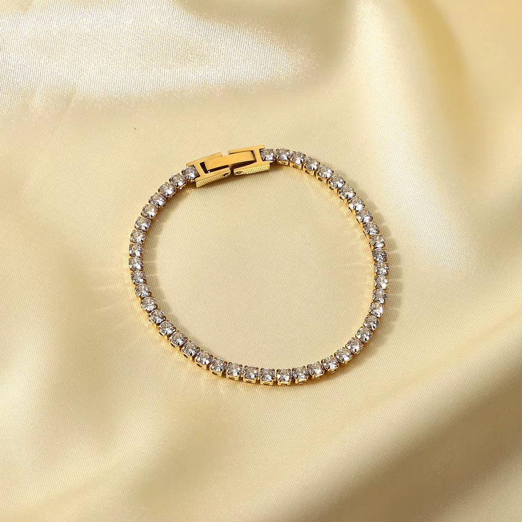 Ritz Solitaire tennis bracelet featuring 18k gold PVD plated stainless steel and clear crystals.