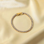 Ritz Solitaire tennis bracelet featuring 18k gold PVD plated stainless steel and clear crystals.