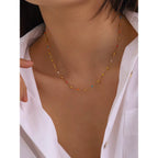 Close-up of the secure gold lobster clasp and adjustable extender links on a dainty choker.