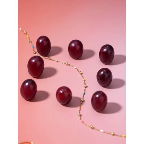 Waterproof gold station chain choker with multicolor accents for swimming and beach wear.