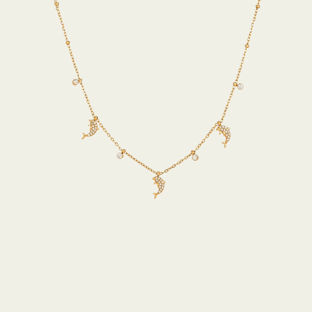 Waterproof gold dolphin charm necklace for swimming and active daily lifestyles.