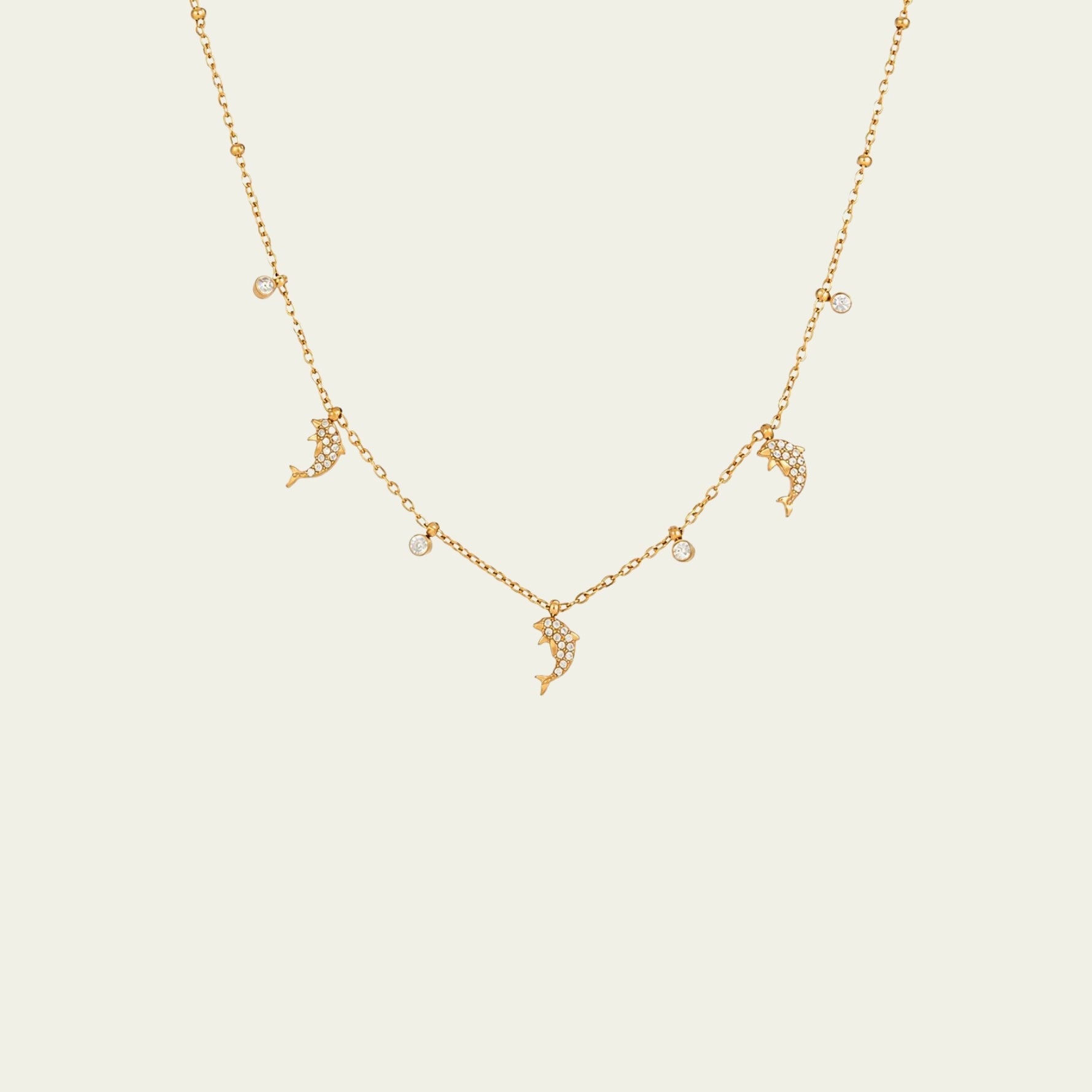 Waterproof gold dolphin charm necklace for swimming and active daily lifestyles.