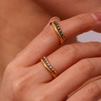Verdant emerald green double band ring in 18k gold PVD plated stainless steel on a white background.