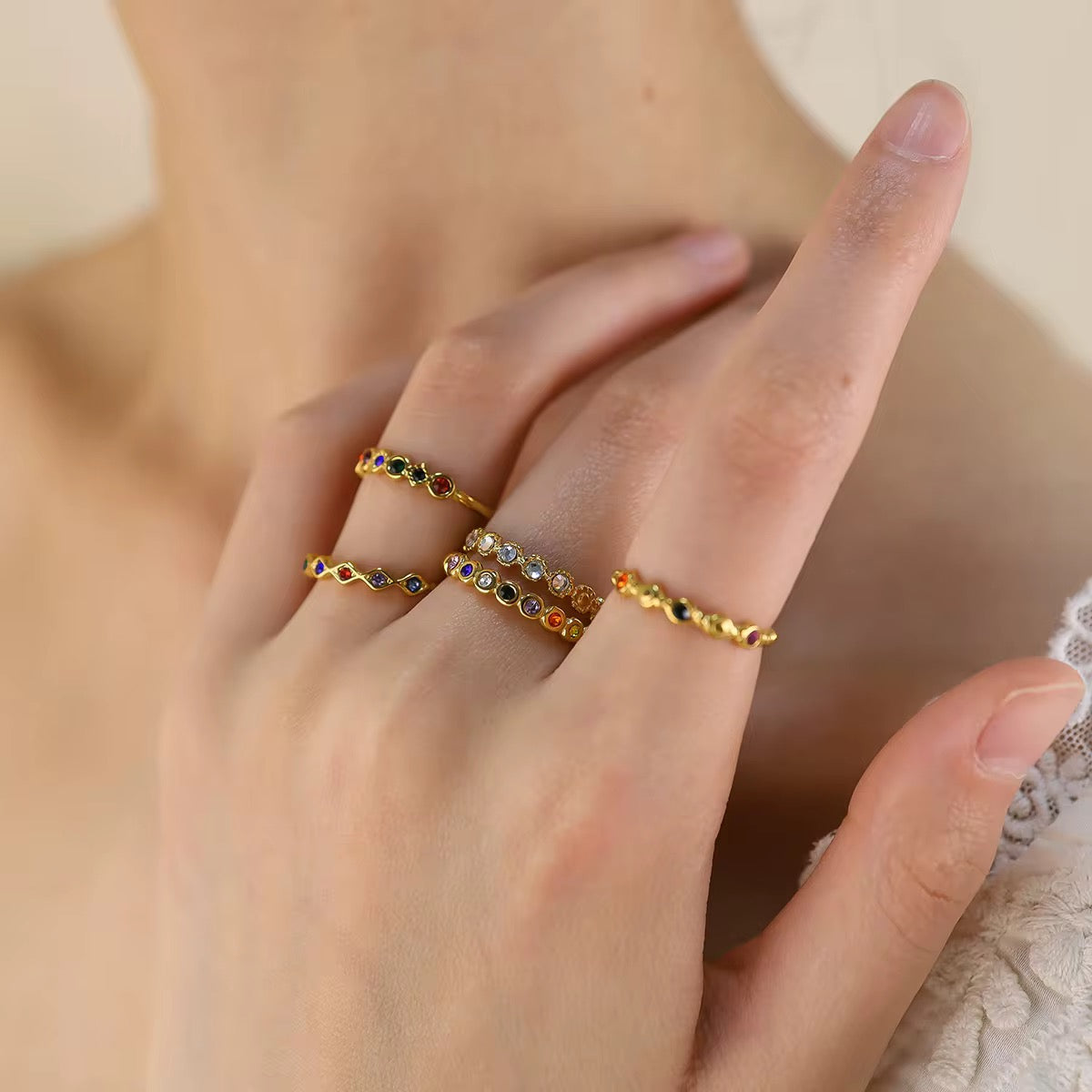 Iris multicolor crystal wave ring in 18k gold PVD plated stainless steel on white background.