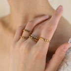 Waterproof gold open band ring featuring a continuous row of round multi-colored crystals.