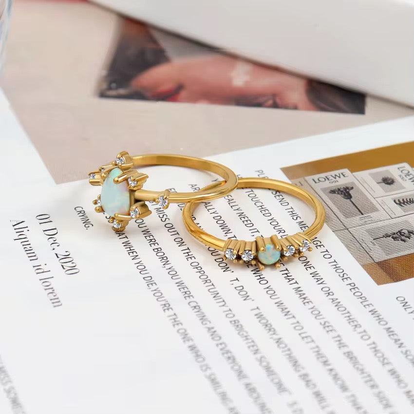 Tarnish-free 316L stainless steel ring showing pear shaped authentic gemstone on light silk fabric.