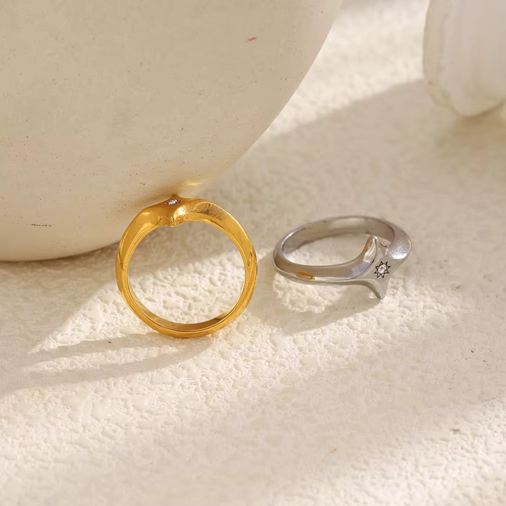 Waterproof gold signet ring with engraved starburst design and clear center crystal.