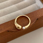 Luxury ocean-proof gold jewelry featuring an adjustable open-style ring set with elegant pearls.