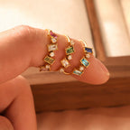 Three Royal Heritage gold cluster rings displayed with variant labels on an off-white background.