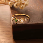 Hypoallergenic Princess Cambridge ring showcasing blue aquamarine and clear baguette crystals in gold.