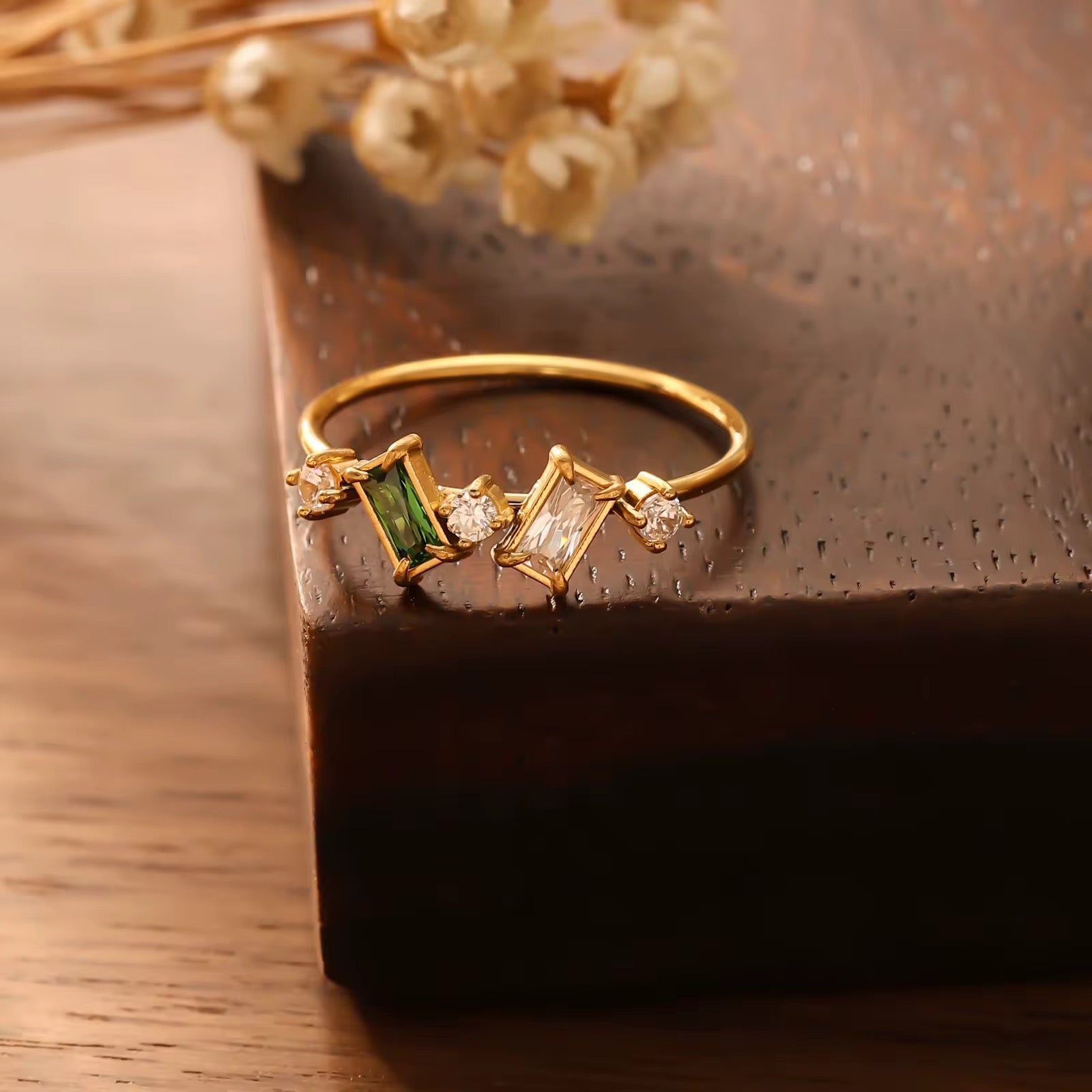 Hypoallergenic Princess Cambridge ring showcasing blue aquamarine and clear baguette crystals in gold.