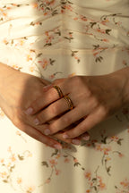Green gemstone curved ring and clear crystal contoured band in yellow gold. Dainty May birthstone jewelry set, unique stackable matching promise rings gift idea for her.