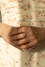 Waterproof gold stacking ring with round iridescent natural opal stone and white crystals.