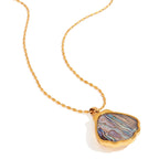Necklace with a multicolored stone pendant on a white background